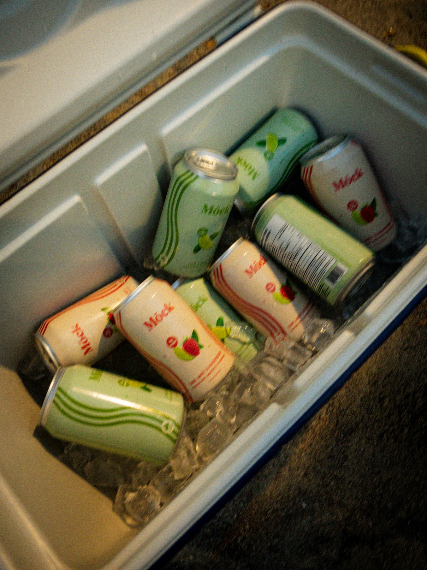 Cans of Mōck on ice in a cooler